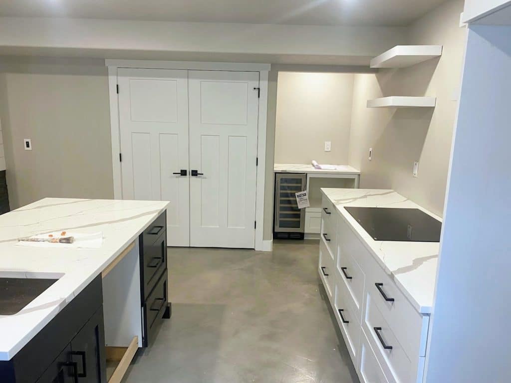 A kitchen with white cabinets and countertops.