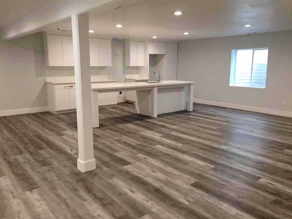 Clean, empty basement with wood floors. Ideal for rental space.