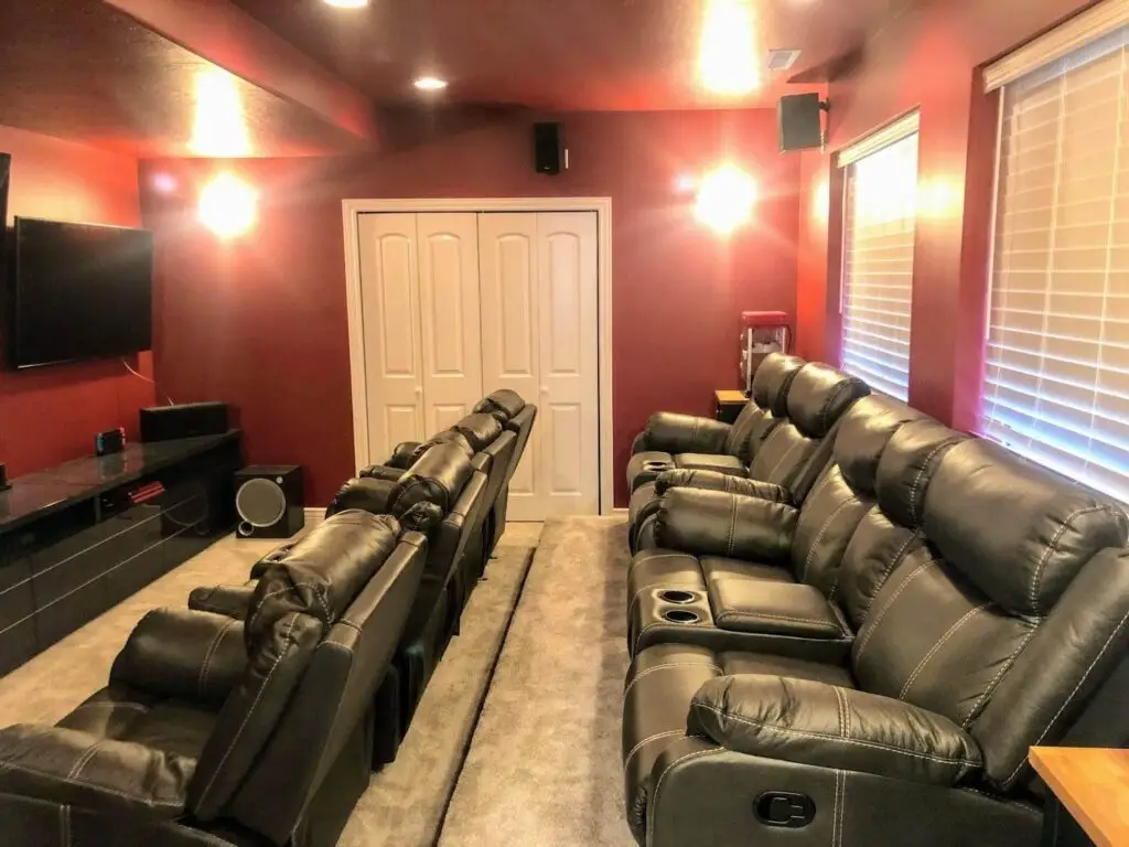 A cozy basement home theater featuring recliners and a large television, perfect for movie lovers to enjoy cinematic experiences. - Creative Construction Solutions A cozy basement home theater featuring recliners and a large television, perfect for movie lovers to enjoy cinematic experiences.