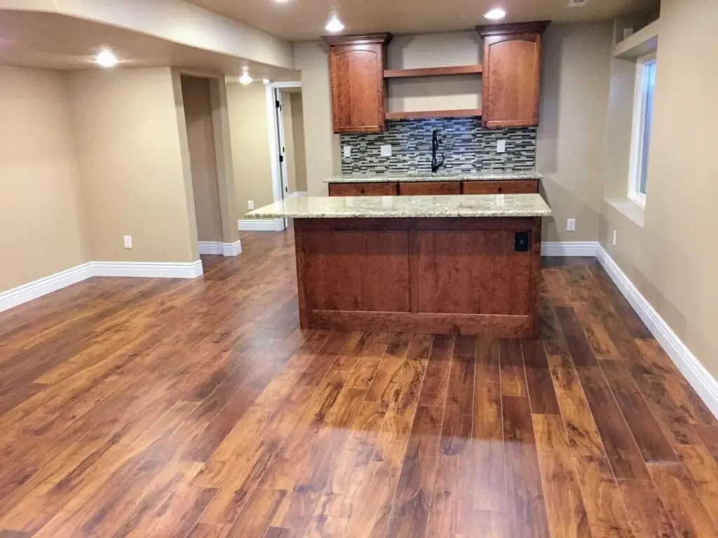 A stylish kitchen with rich wood flooring and cabinets, enhancing its inviting ambiance