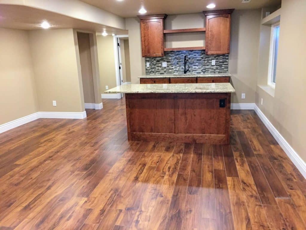 A stylish kitchen with rich wood flooring and cabinets, enhancing its inviting ambiance