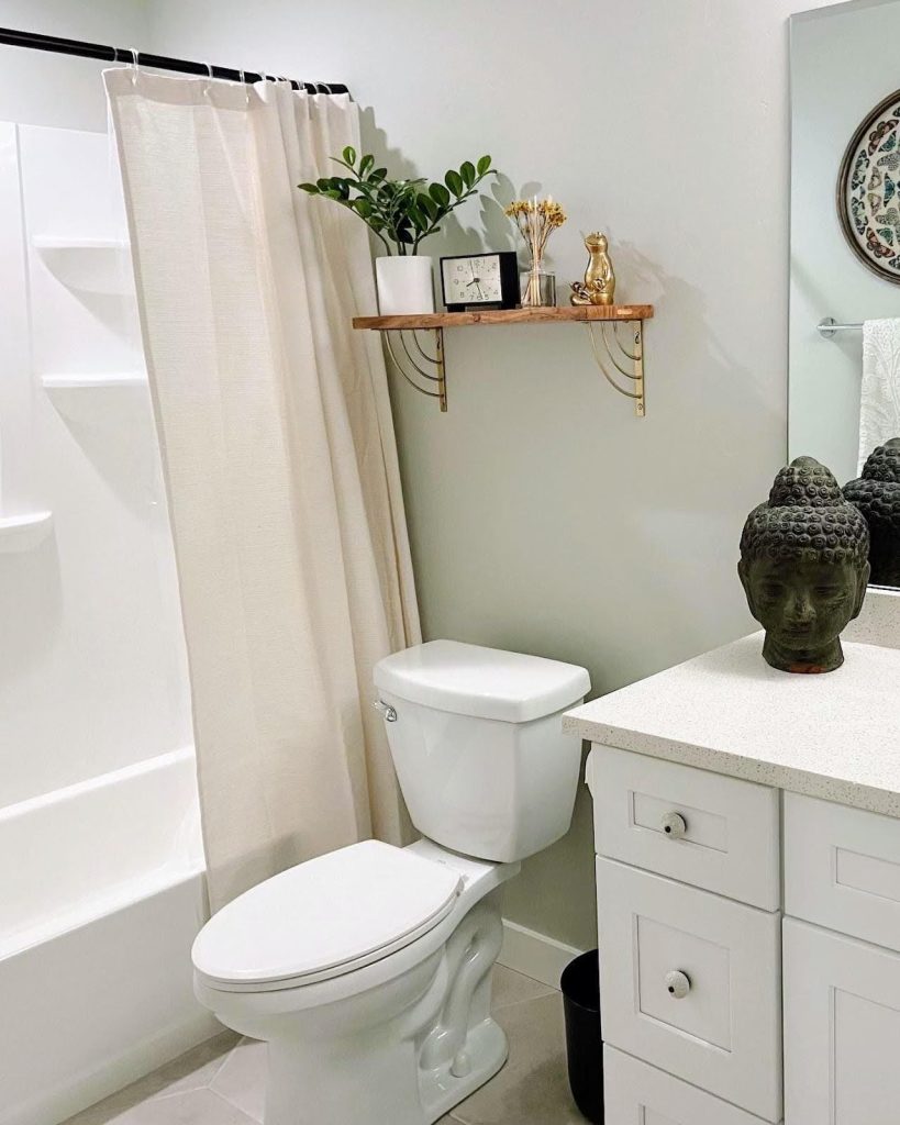 A tidy bathroom featuring sleek white cabinets and a toilet, emphasizing simplicity