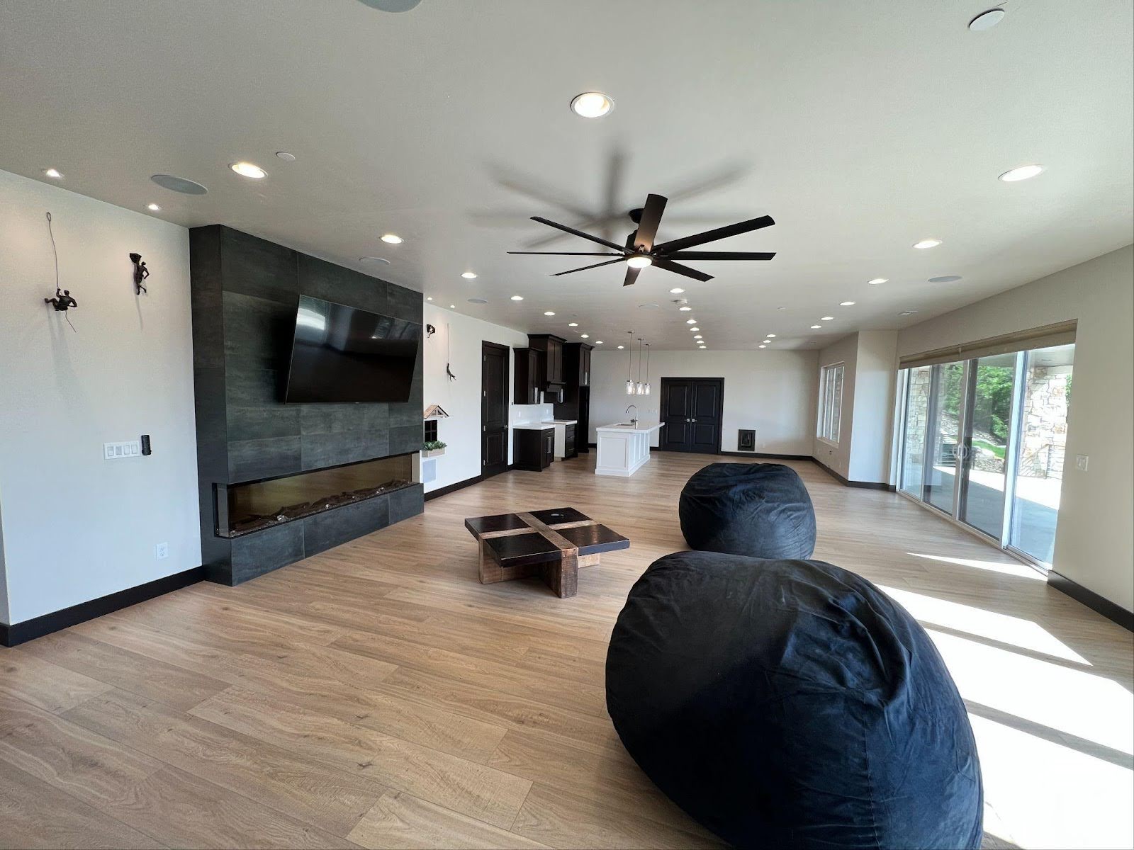 A cozy living room with a ceiling fan and colorful bean bags