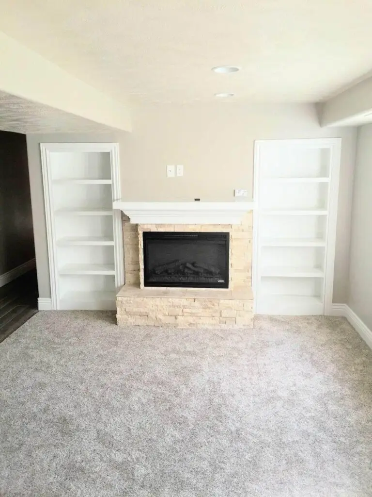 Kitchenette-Bars-Lehi-1-1-1024x683 - Creative Construction Solutions A cozy room with a fireplace and bookshelves, creating a warm atmosphere