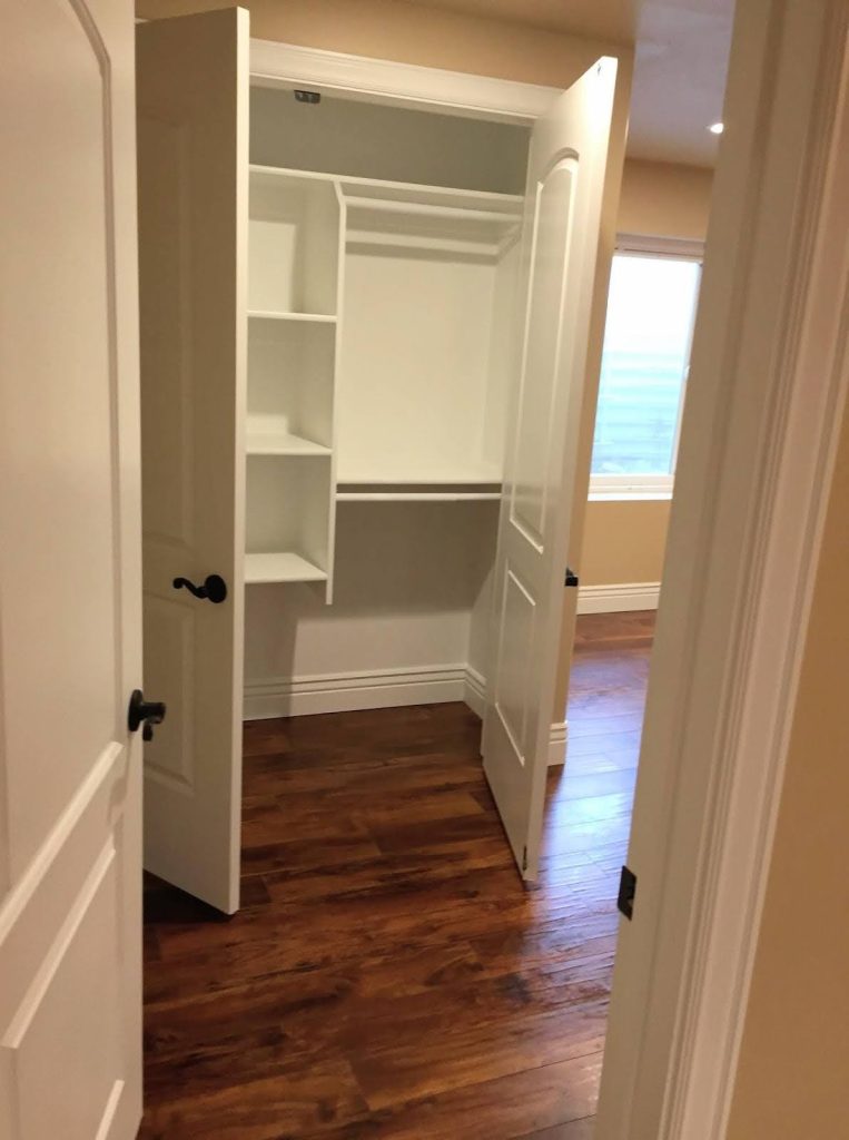 A neatly arranged closet with shelves inside and a door, designed for optimal storage solutions