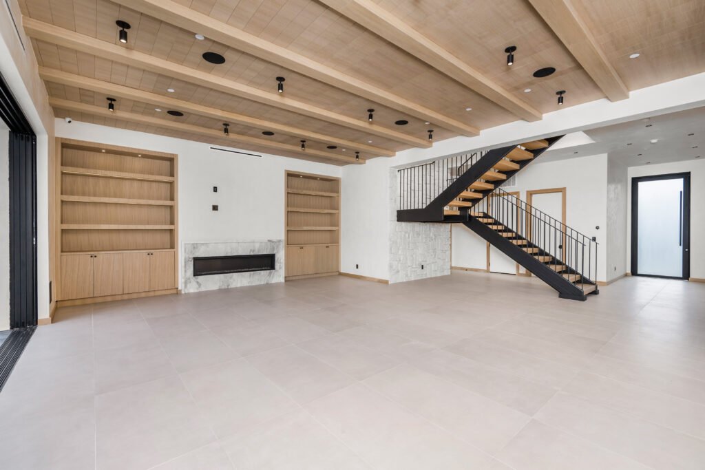 a living room with a wooden staircase and a stair case - Creative Construction Solutions a living room with a wooden staircase and a stair case , Creative Construction Solutions