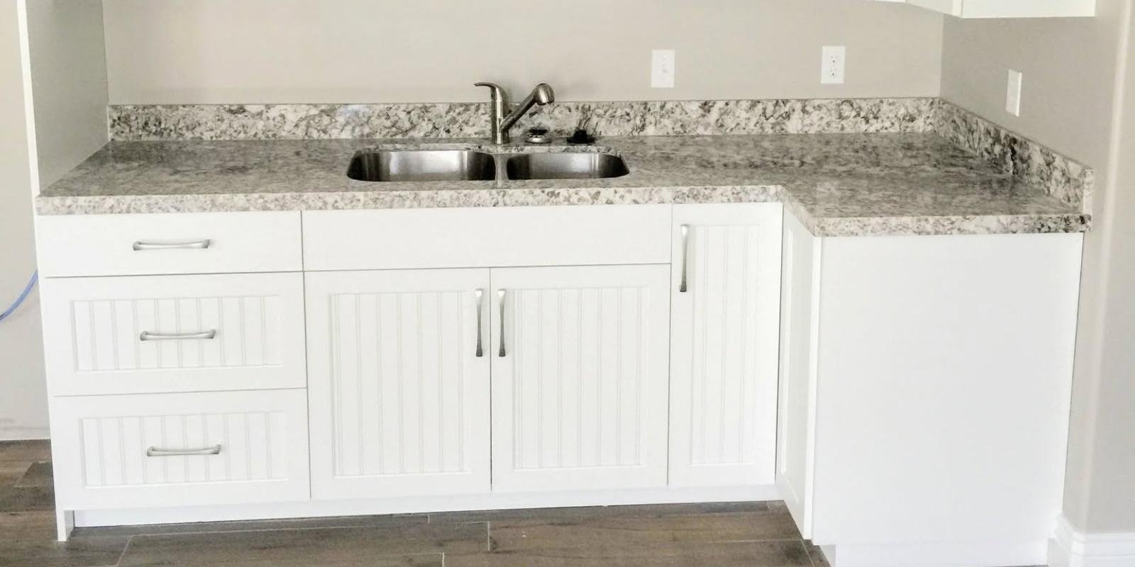 basement finishing permits sandy utah: complete homeowner's guide 2 A basement sink set into a modern engineered stone countertop, showcasing a completed installation that aligns with Sandy Utah basement finishing permits building codes requirements.
